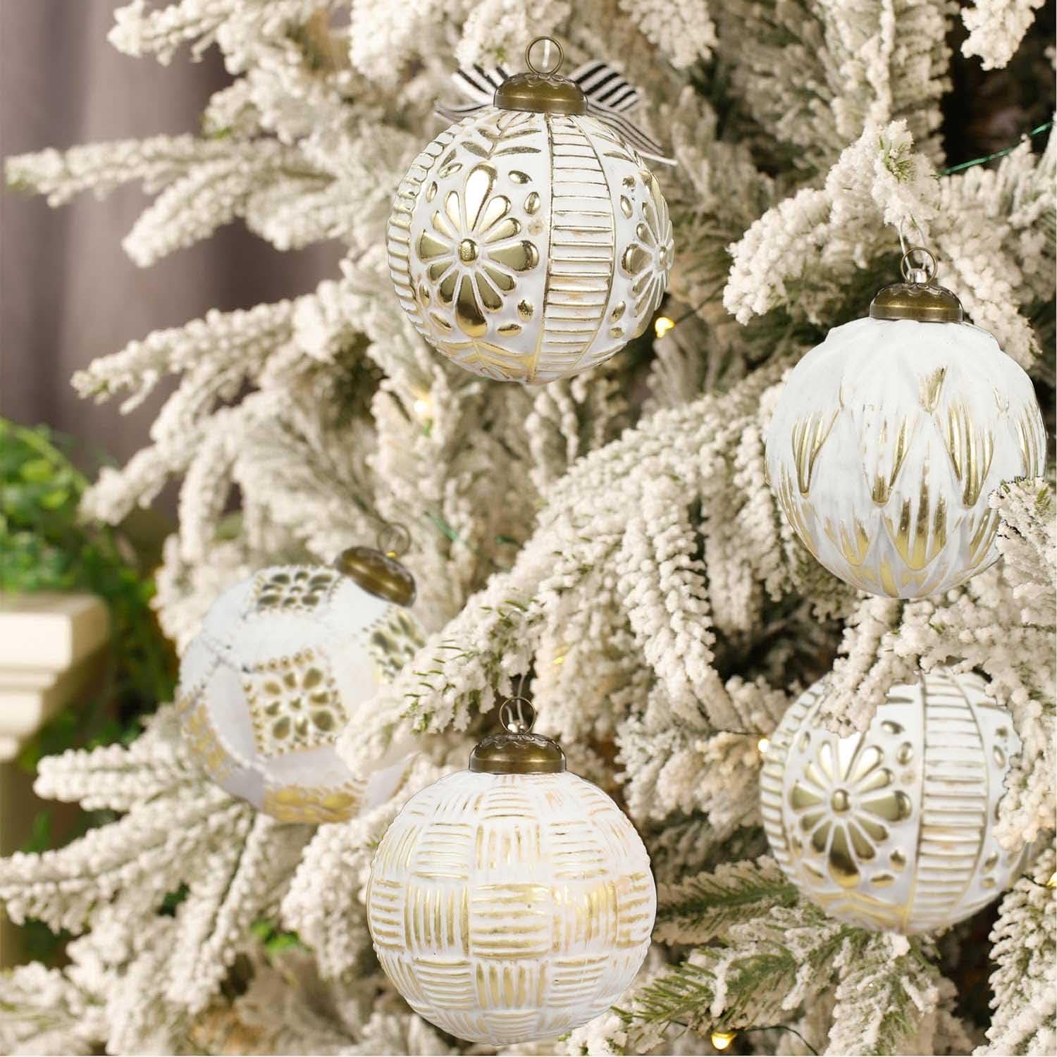 holiday ball decorations hanging on tree white and gold