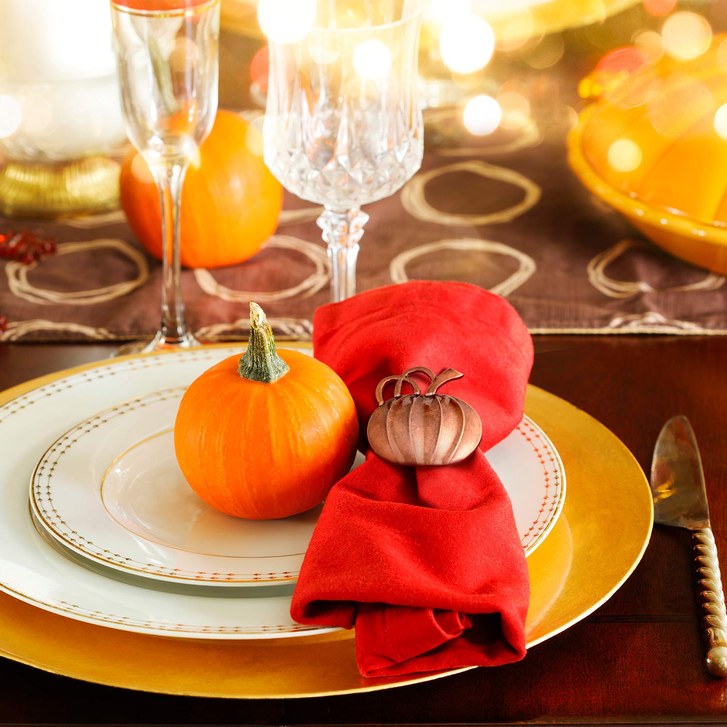 bronze pumpkin napkin ring around cloth napkin on fall table setting