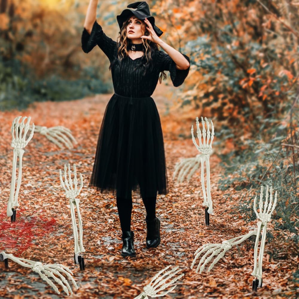 witch standing between skeleton yard stakes