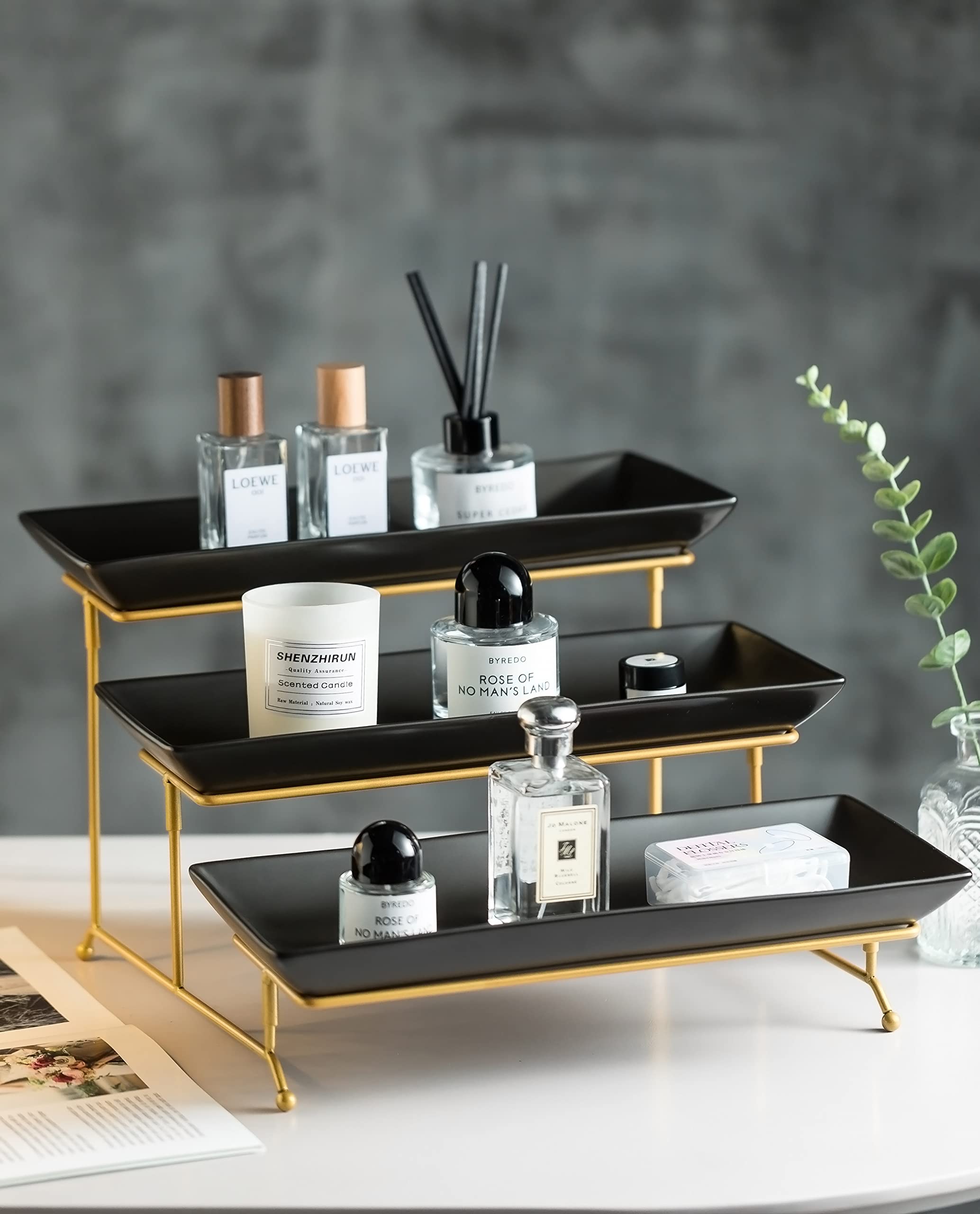 gold and black item trays bathroom counter top