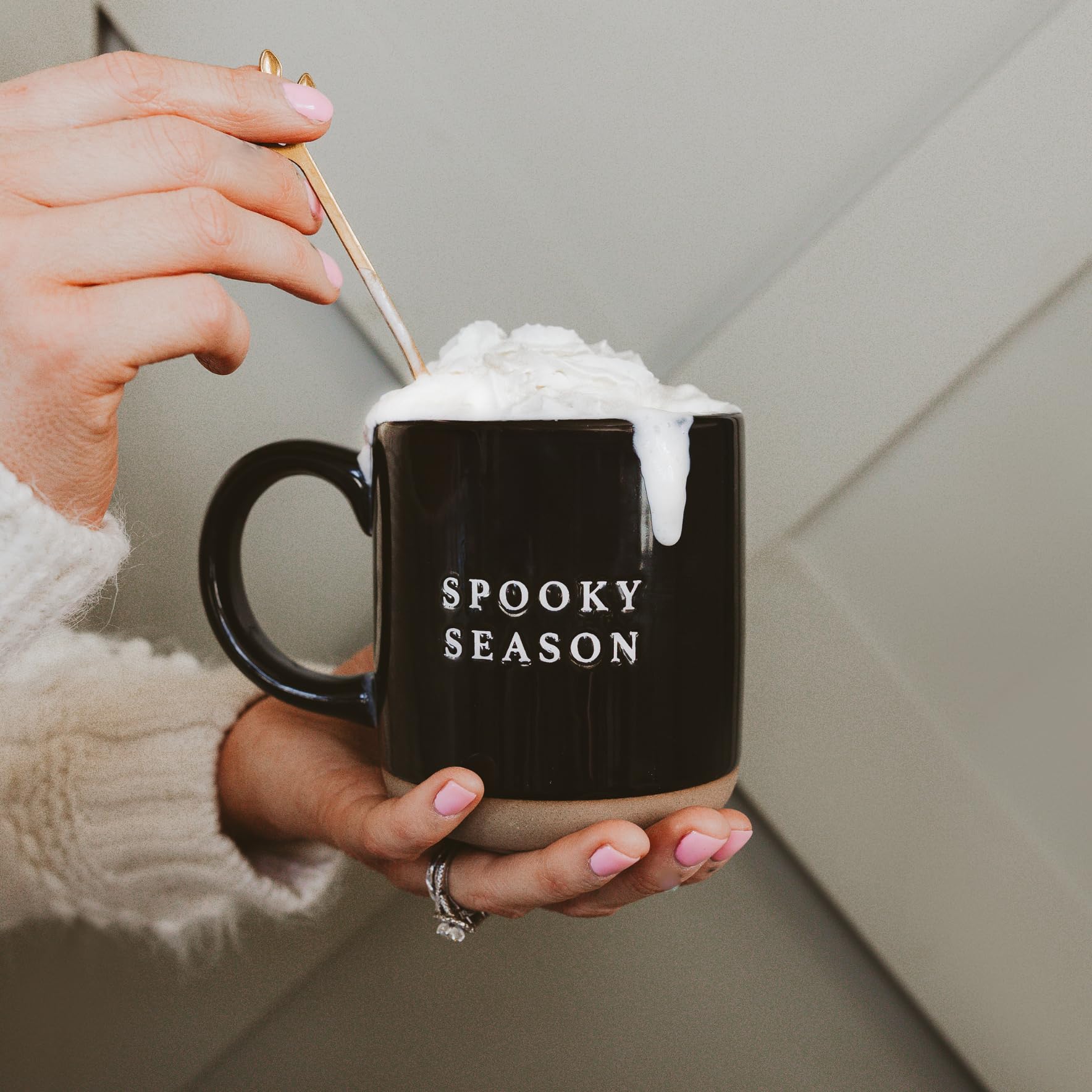 whipped cream filled coffee drink in spooky season coffee mug