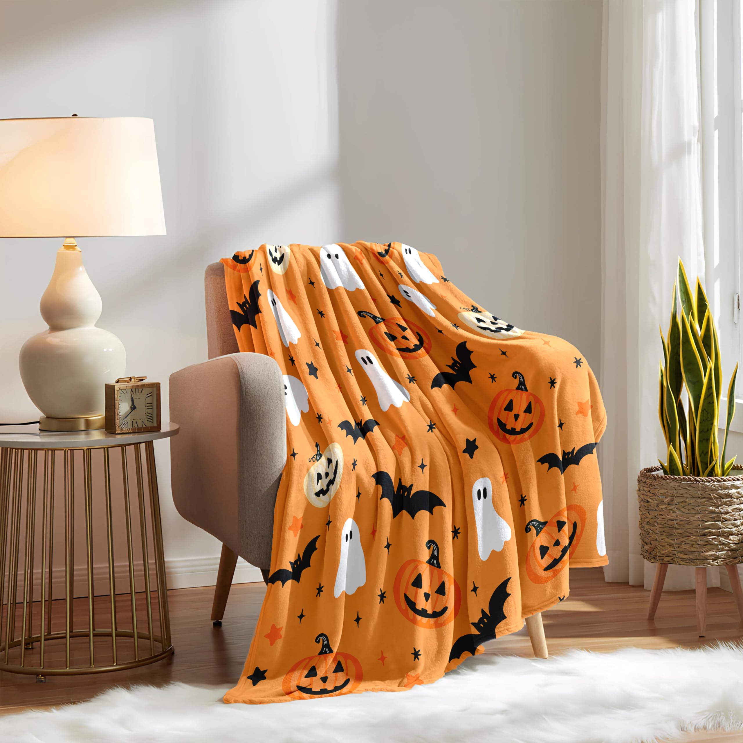 Orange Halloween blanket draped over a chair in a cozy living room.