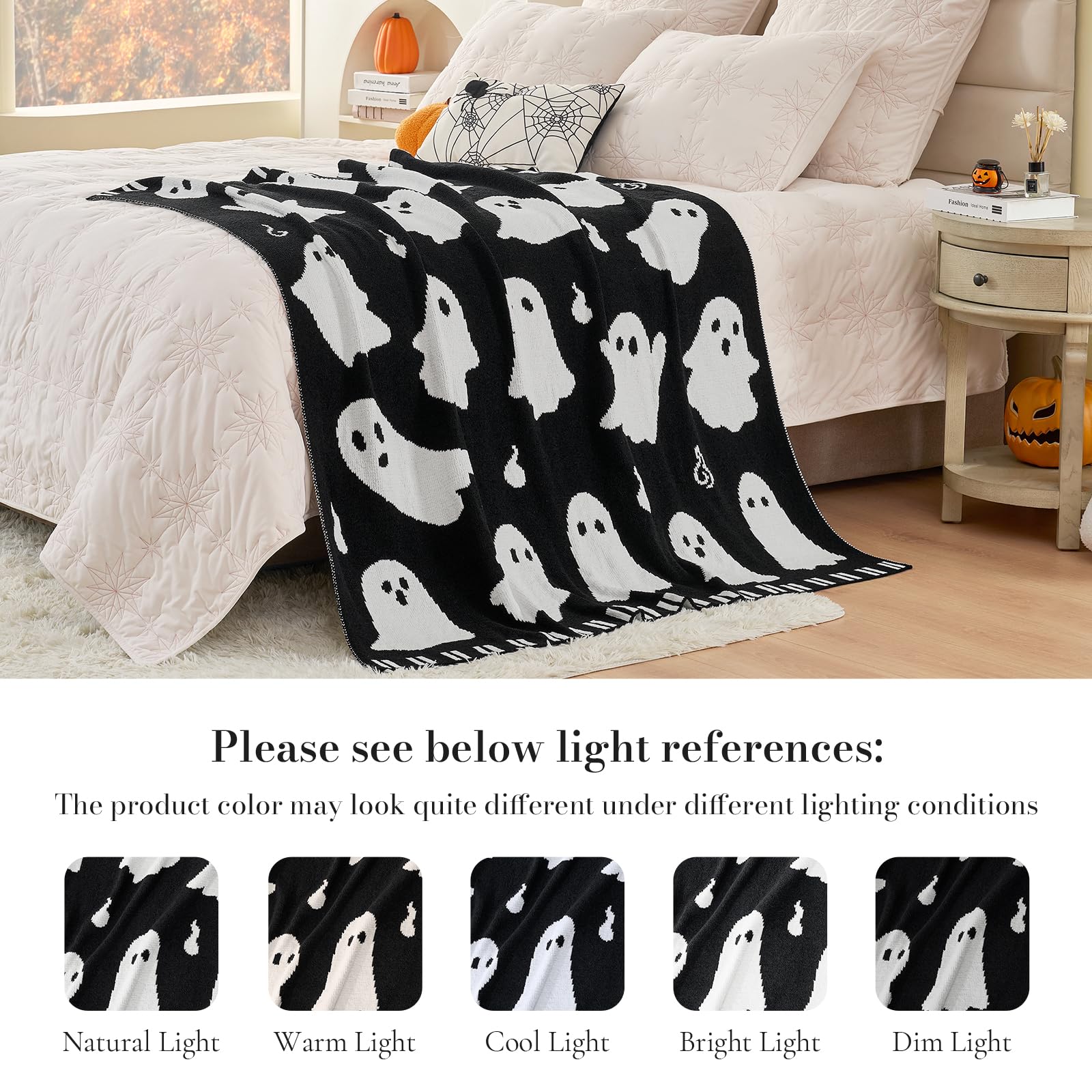 Black blanket with white ghost pattern draped over a bed in a bedroom setting.