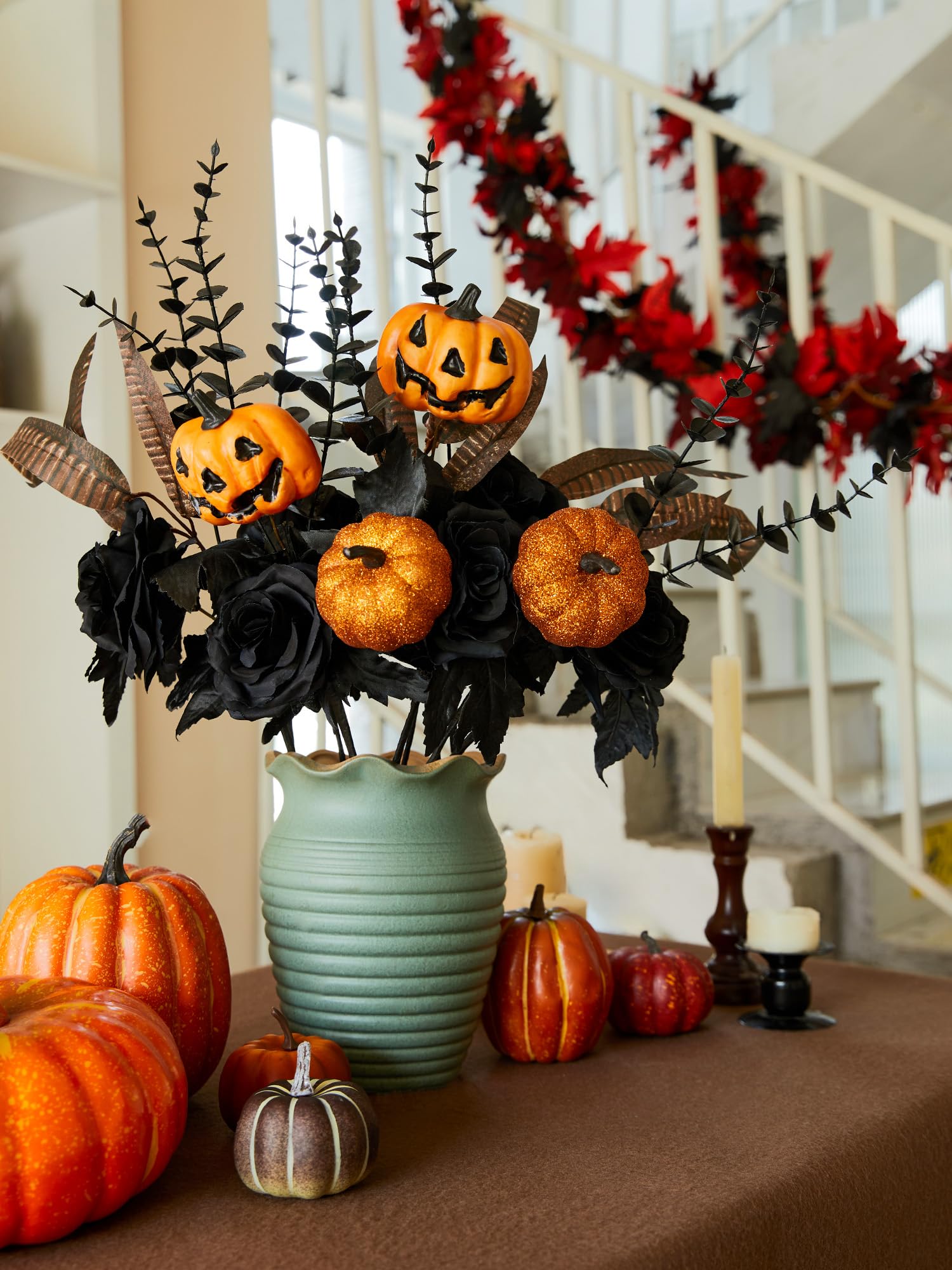 Pumpkin and black artificial roses in turquoise vase