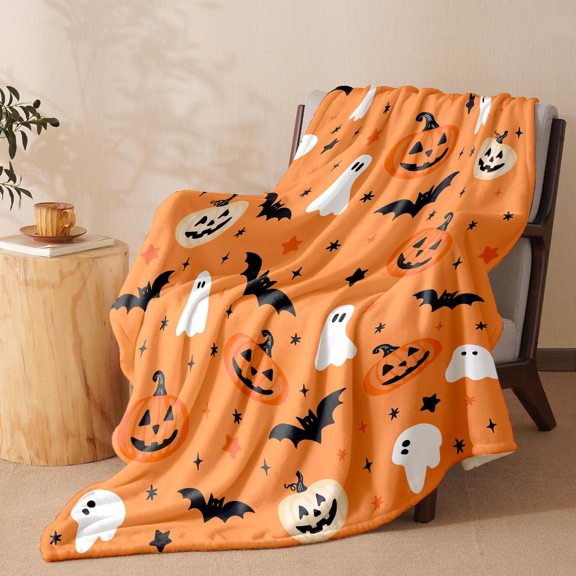 Halloween-themed blanket with pumpkins, ghosts, and bats draped over a chair.