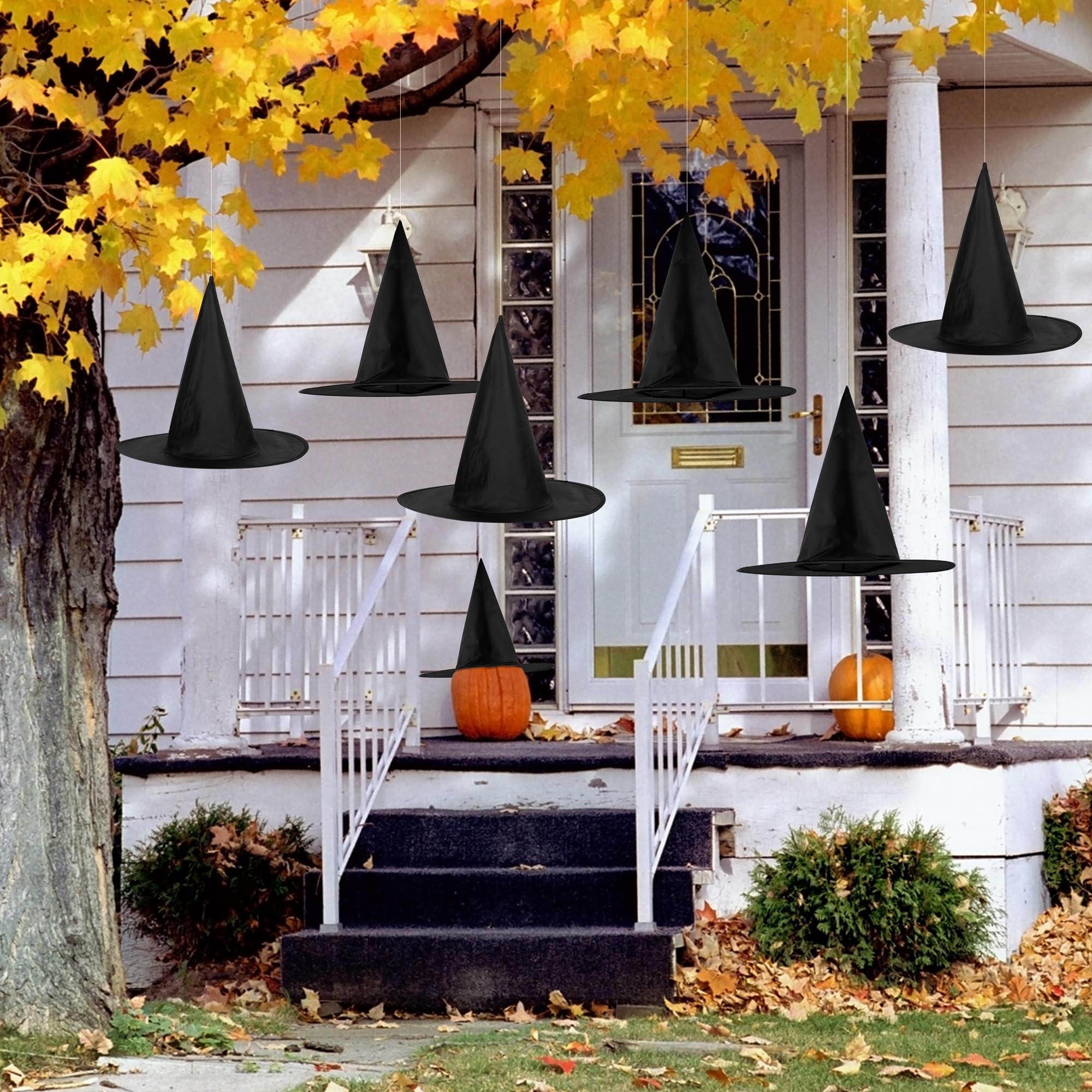 black pointy witch hats hanging in trees