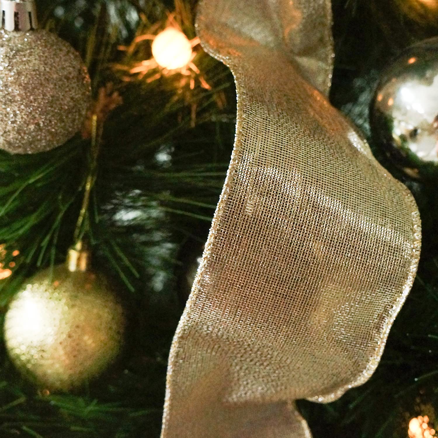 close up view of champagne ribbon decoration on tree
