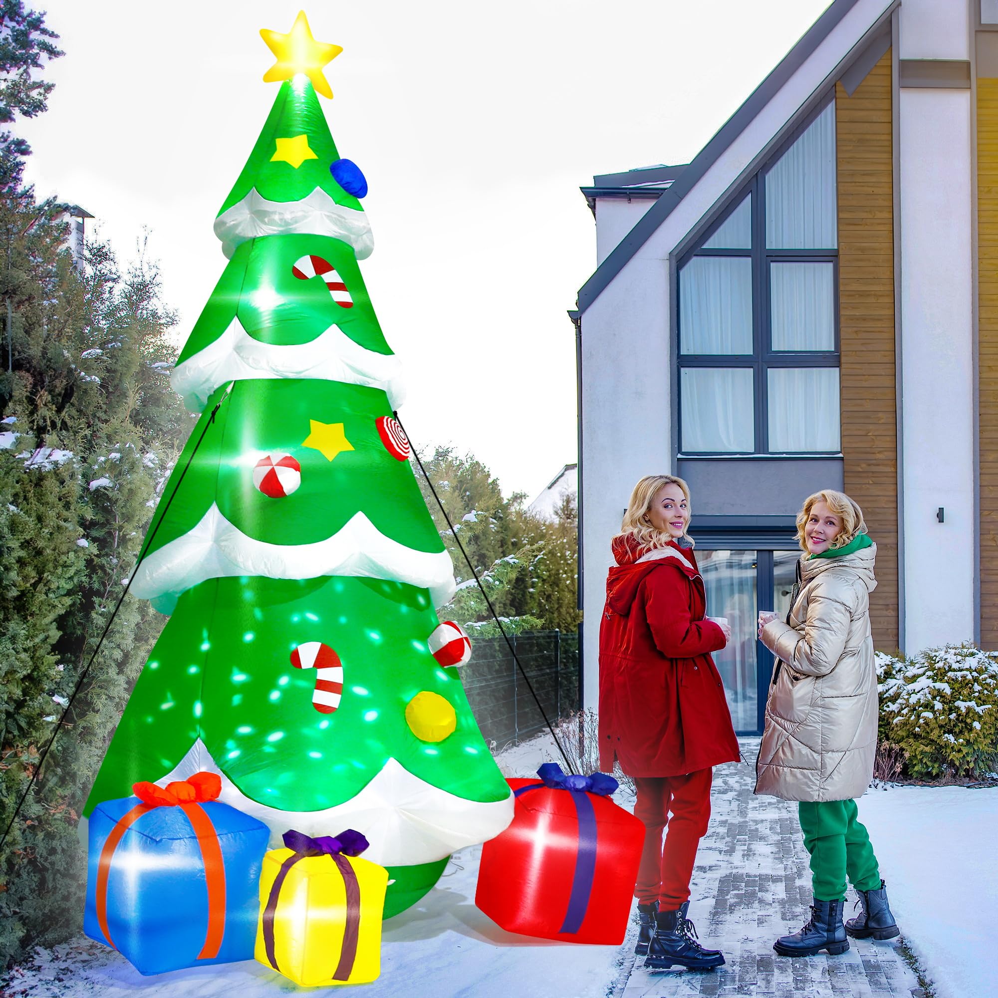 people standing next to holiday tree inflatable in yard