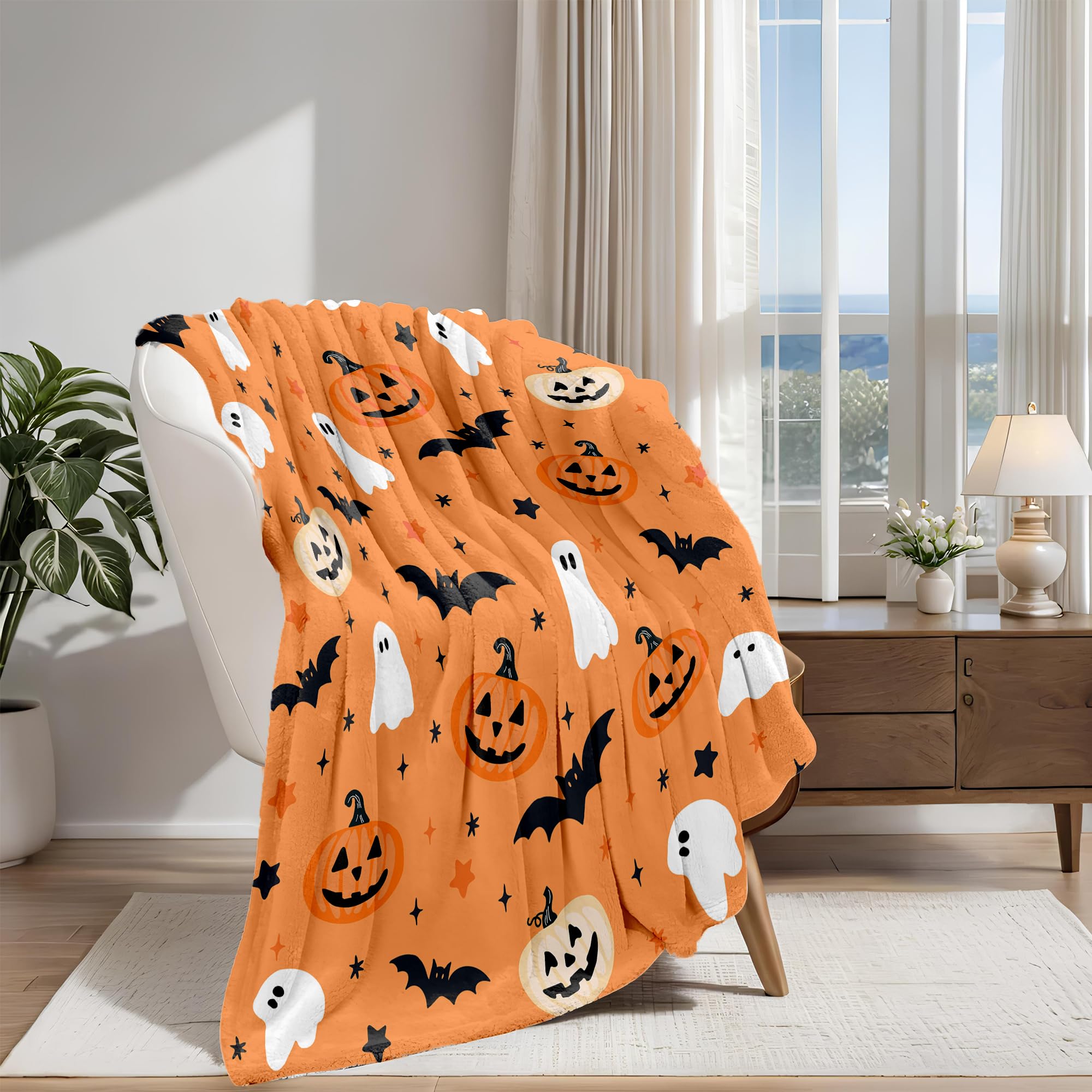 Orange Halloween-themed blanket draped over a chair in a room with a window and plant.