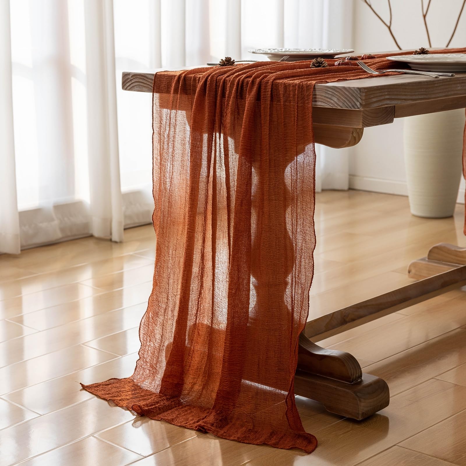 cheesecloth table runner hanging off table