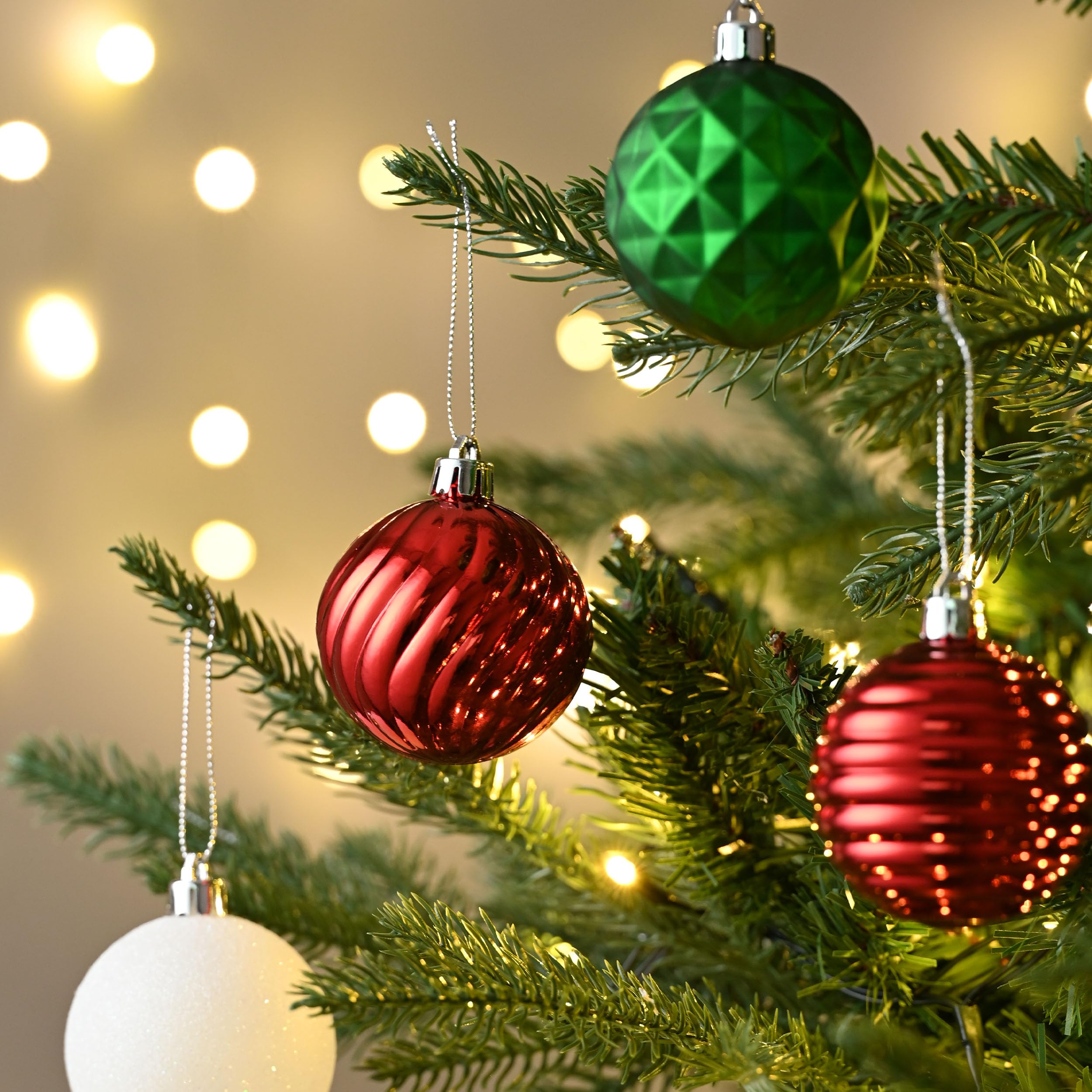 red white green ornaments on Christmas tree