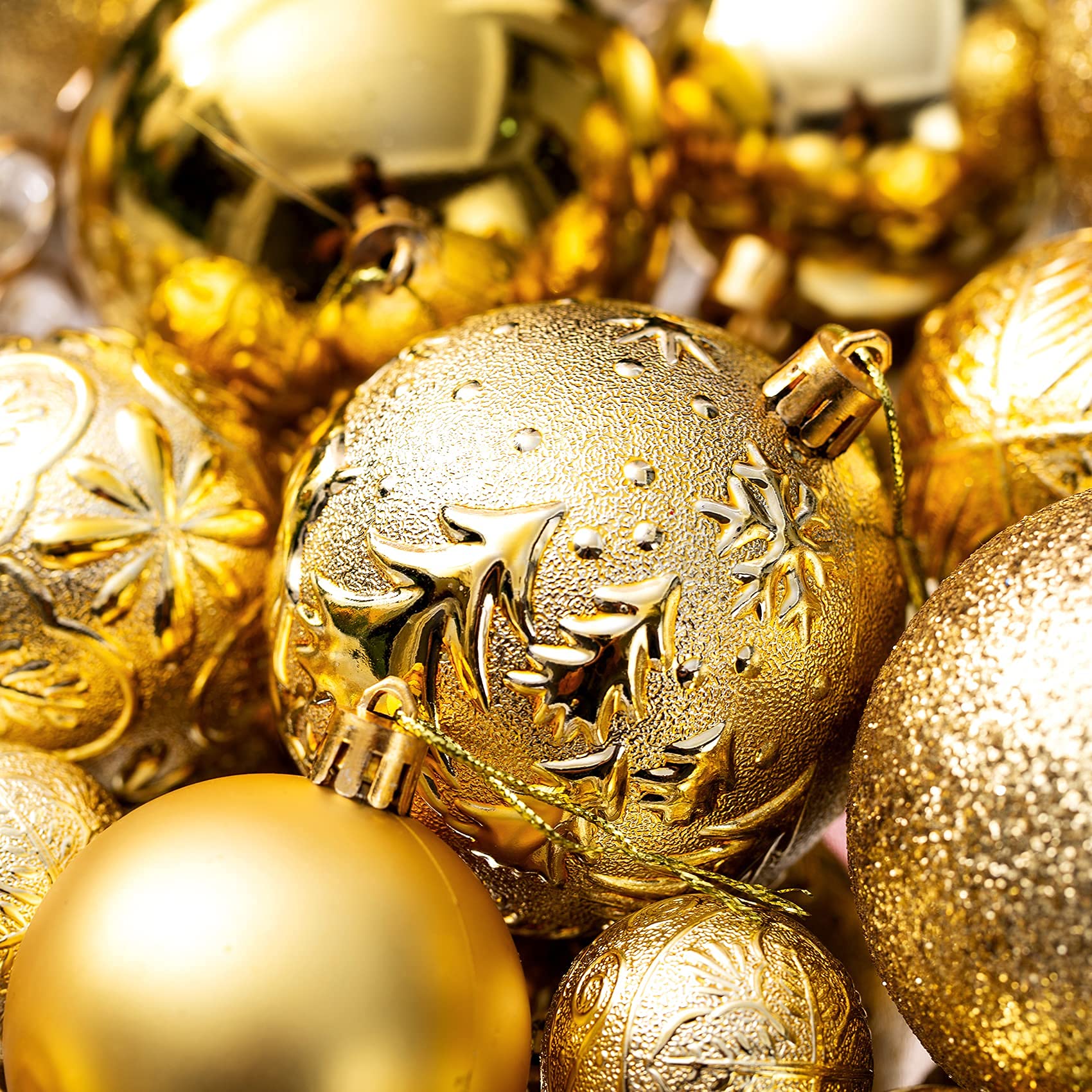 Gold shatterproof Christmas ornaments with different prints and patterns