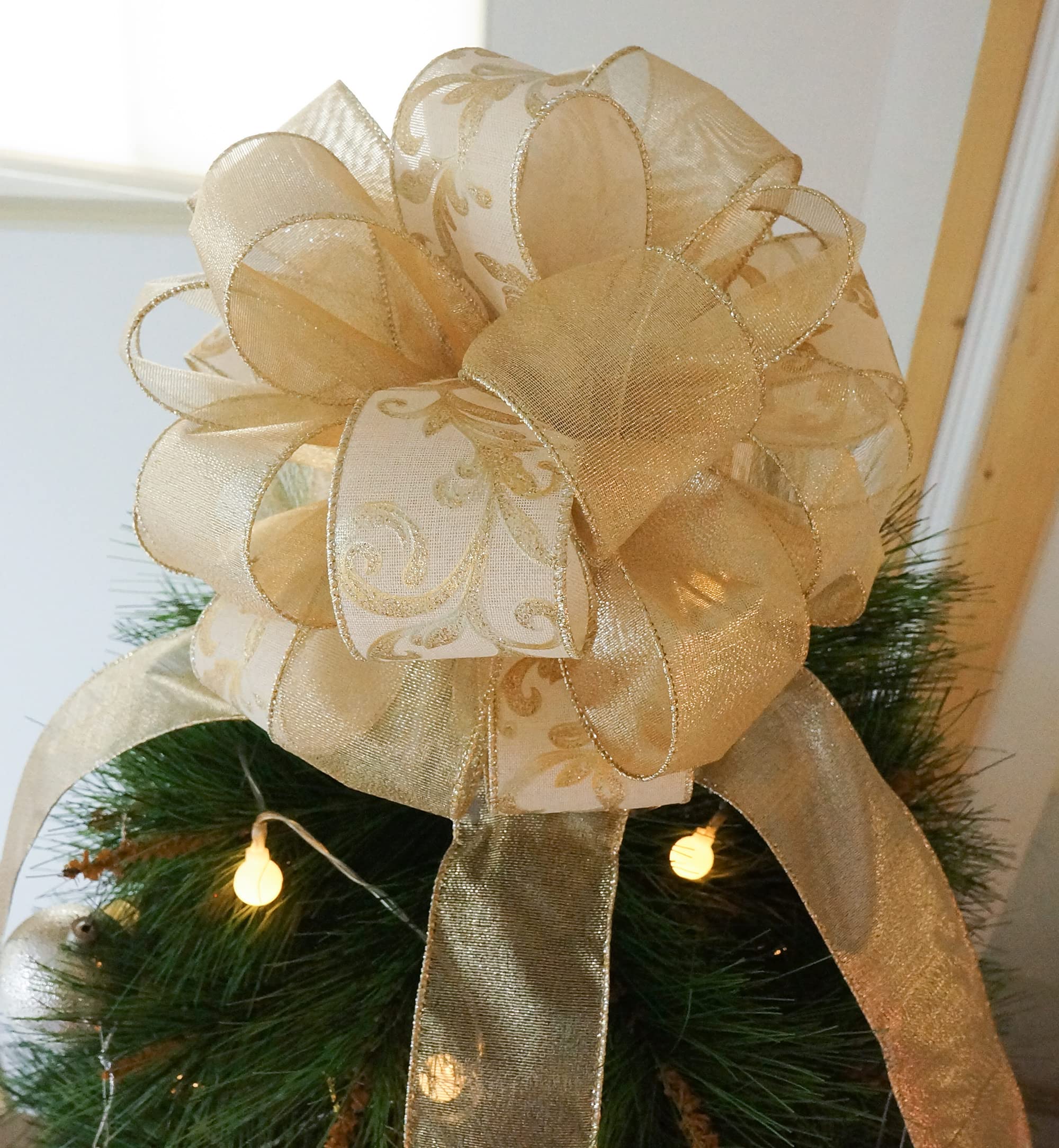 Gold and champagne ribbon tied atop Christmas tree