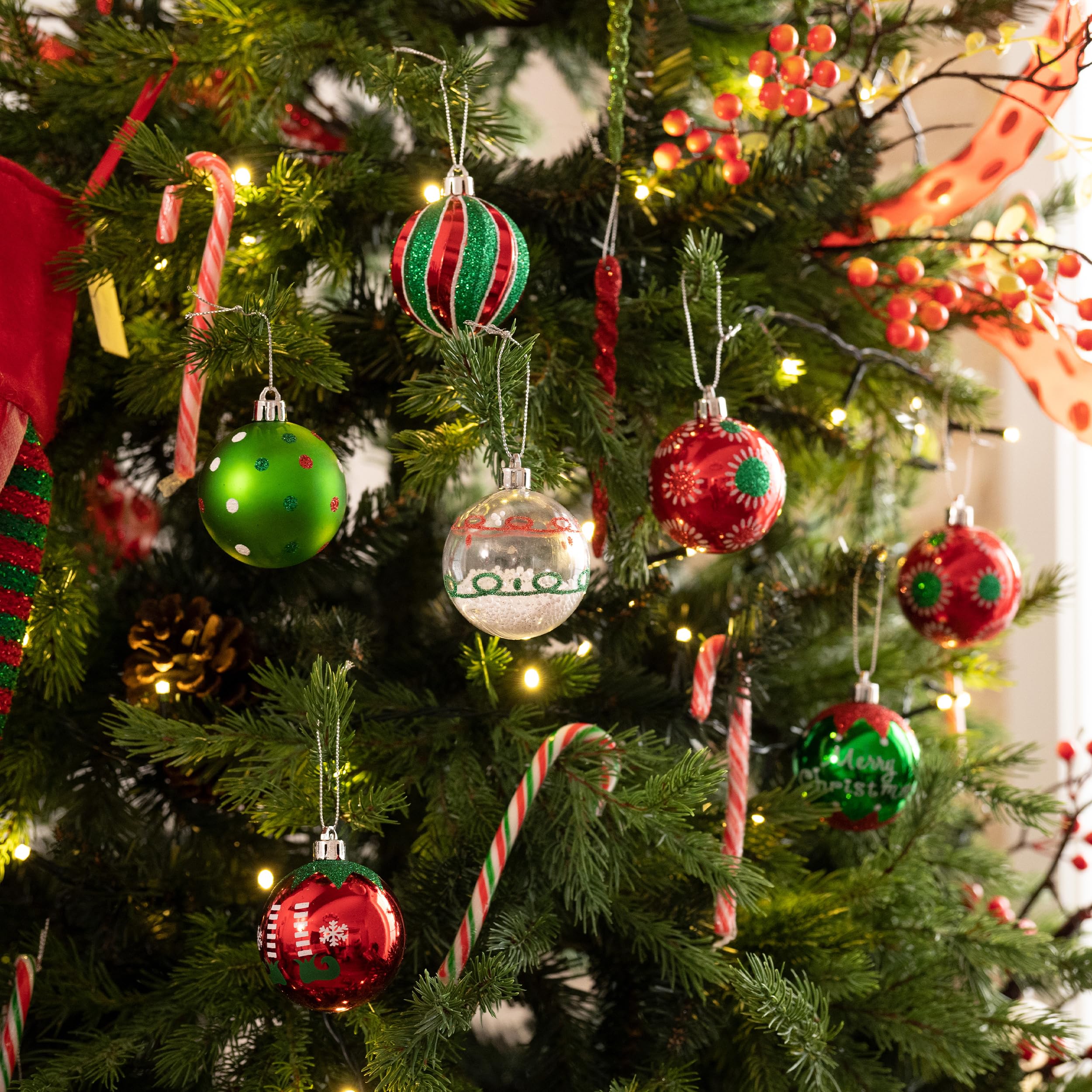 red and green Christmas ornaments hanging on tree