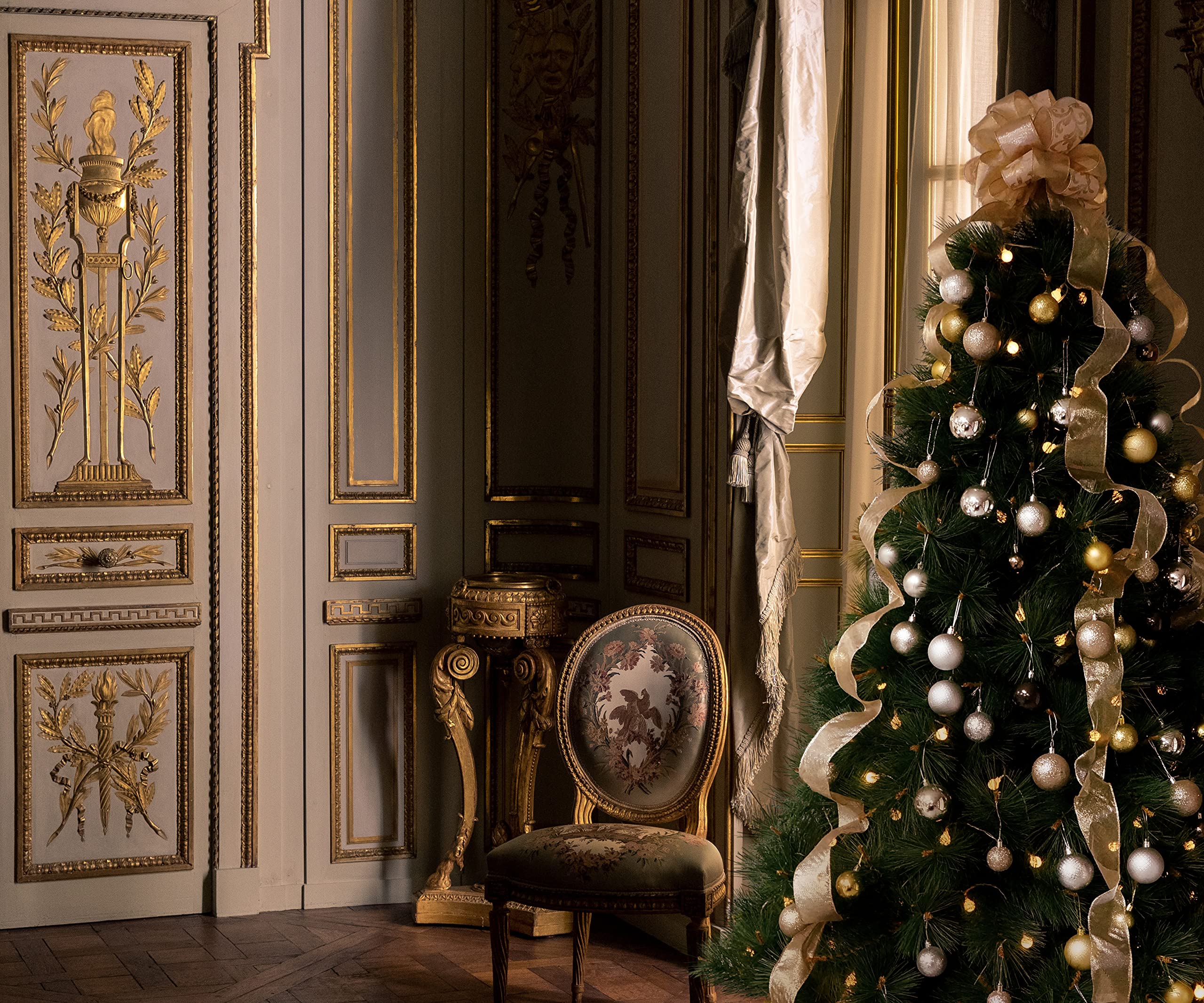 fully decorated Christmas tree with gold and champagne ribbon