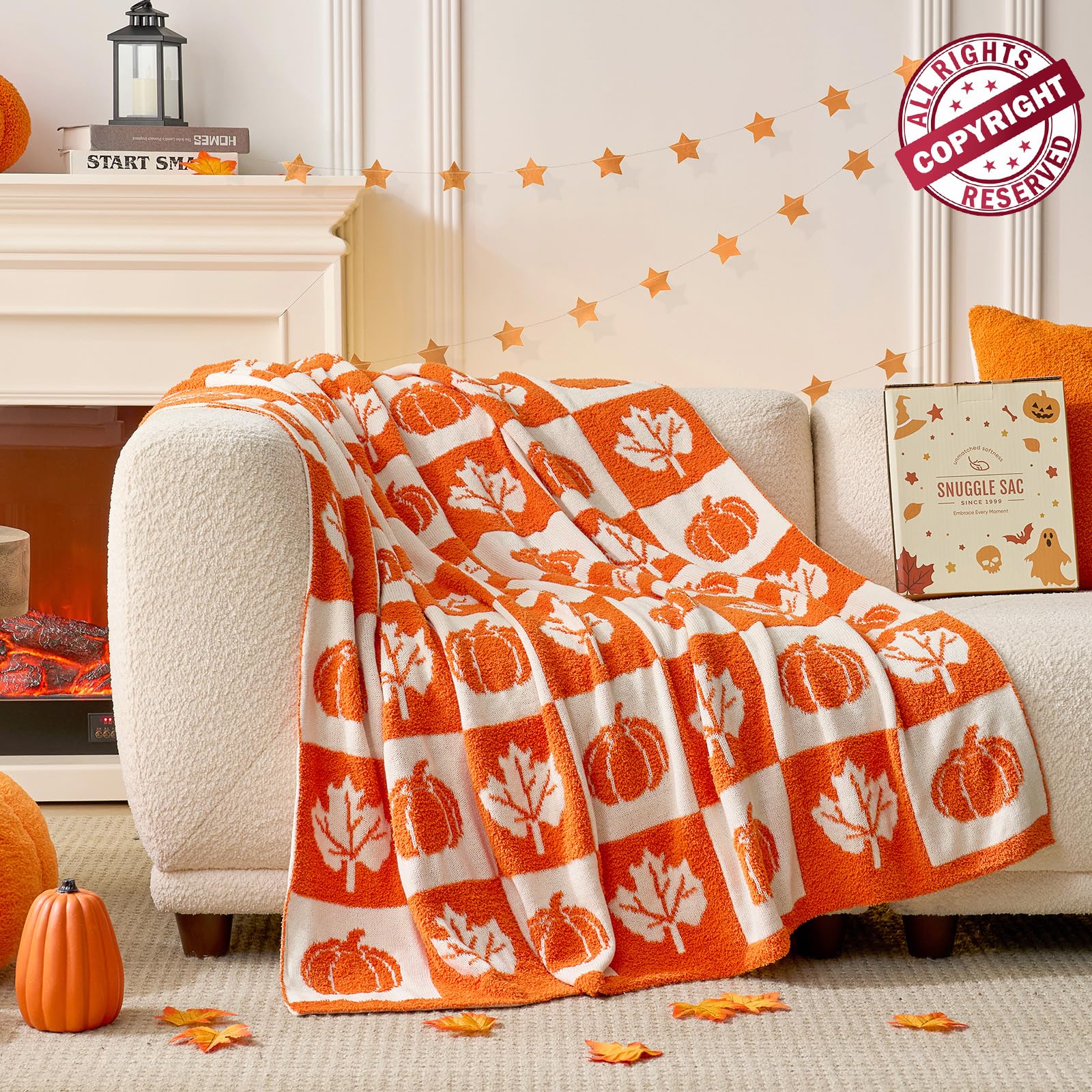 Orange and white patterned blanket draped over a couch in a cozy living room setting.