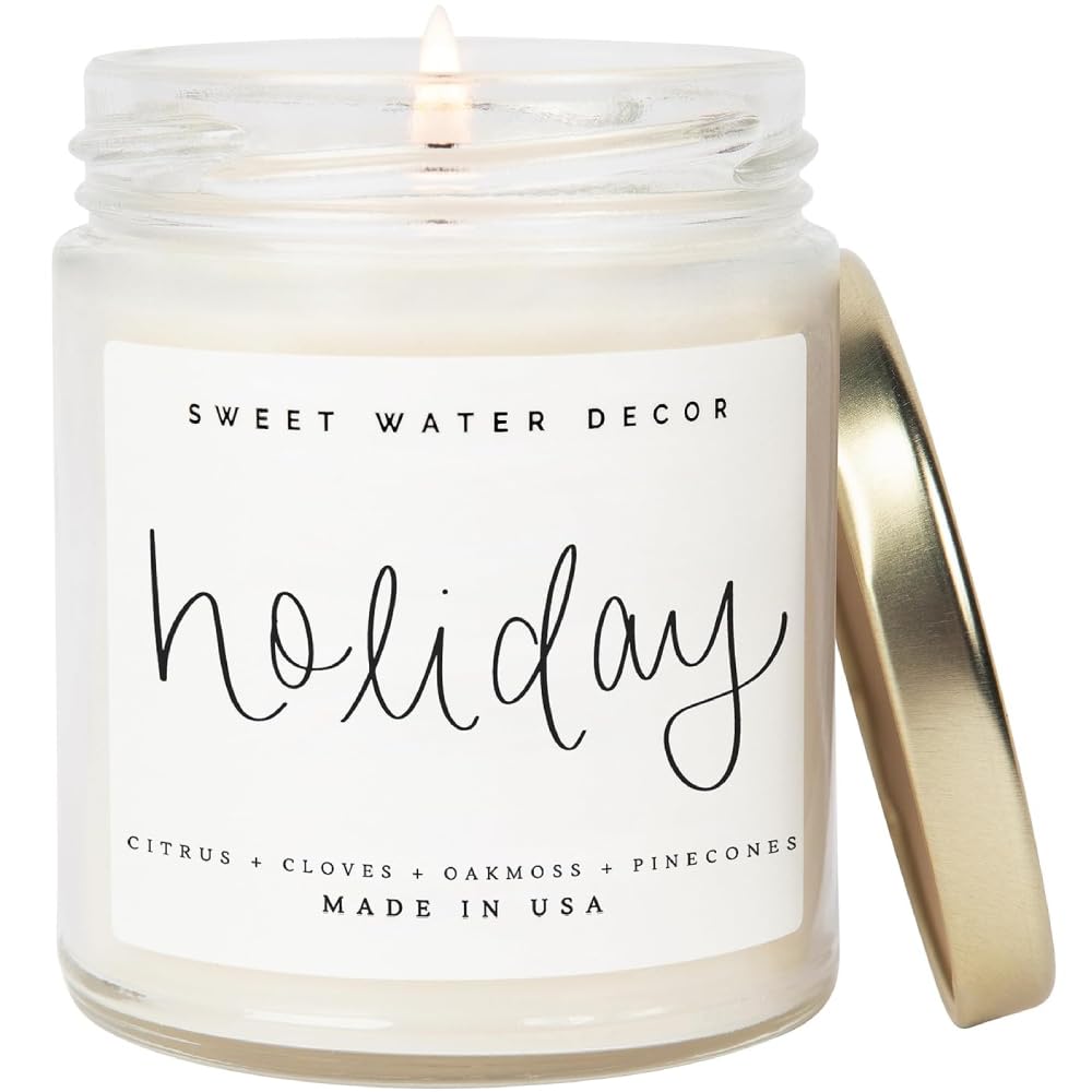 white holiday candle with clear jar and gold lid