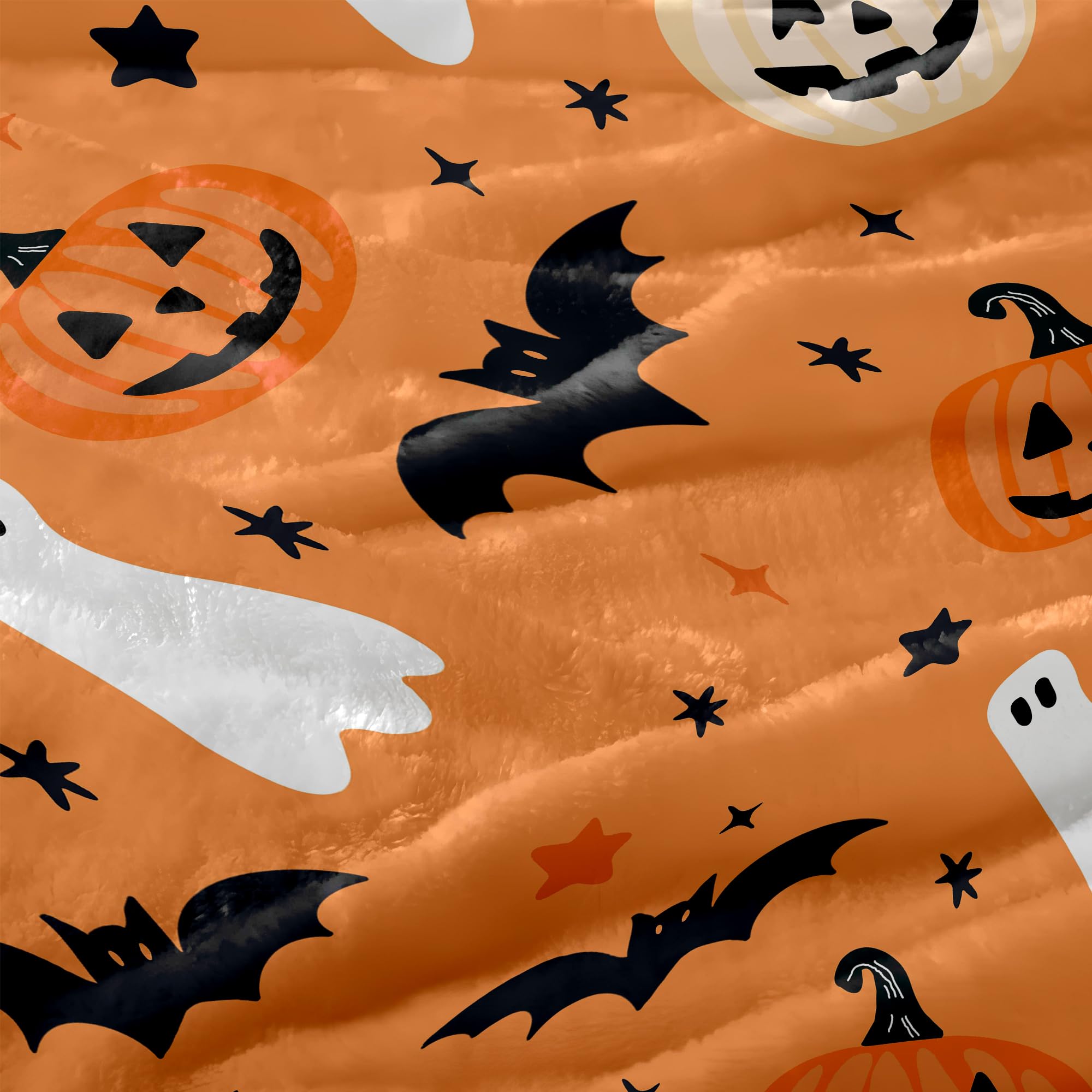 Halloween-themed plush orange blanket fabric with pumpkins, ghosts, bats, and stars.