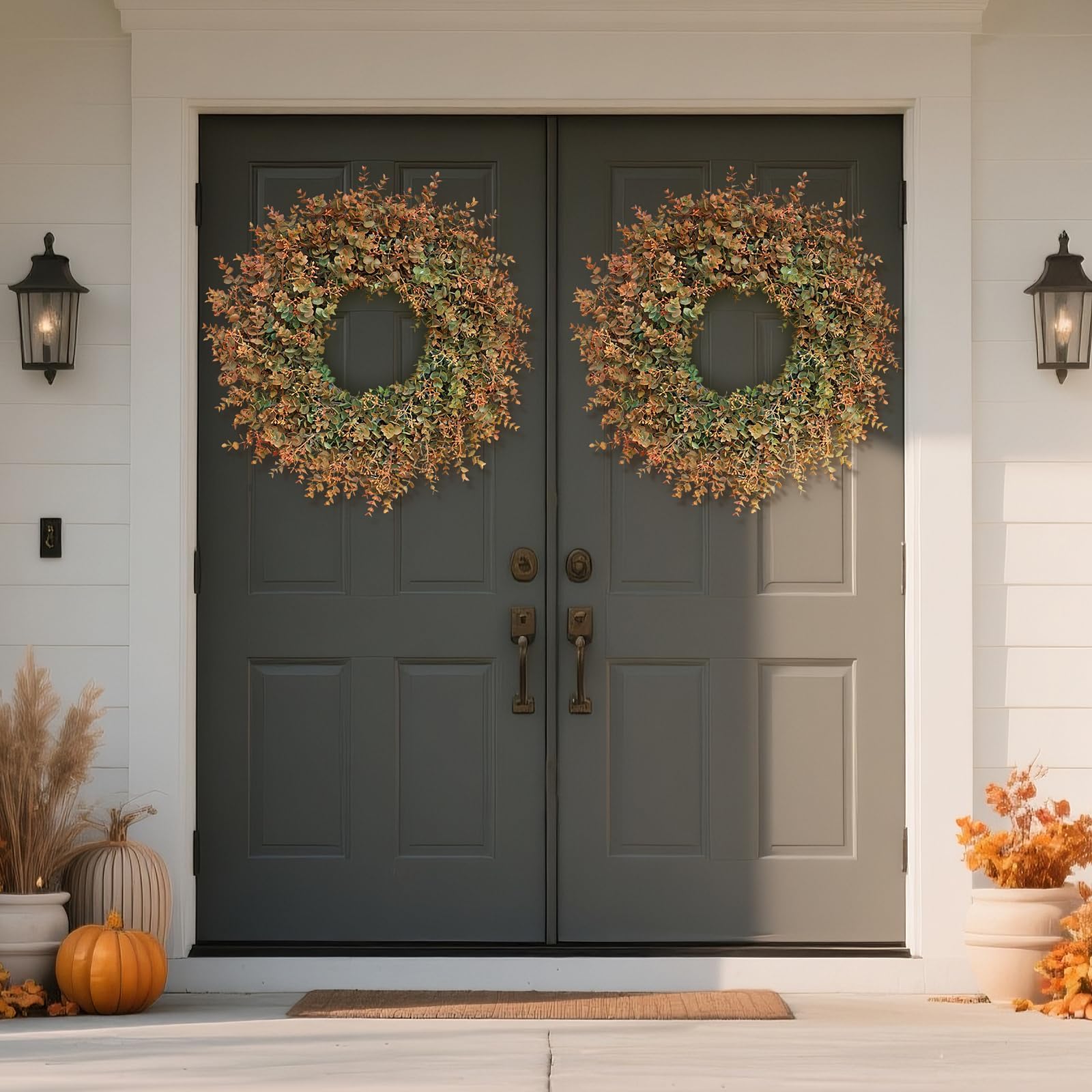 Double front doors with autumn wreaths and decorations 