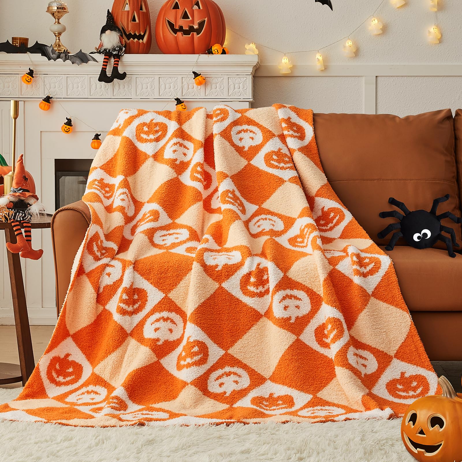 Halloween-themed checkered blanket draped over a couch with pumpkins and decorations in the background.