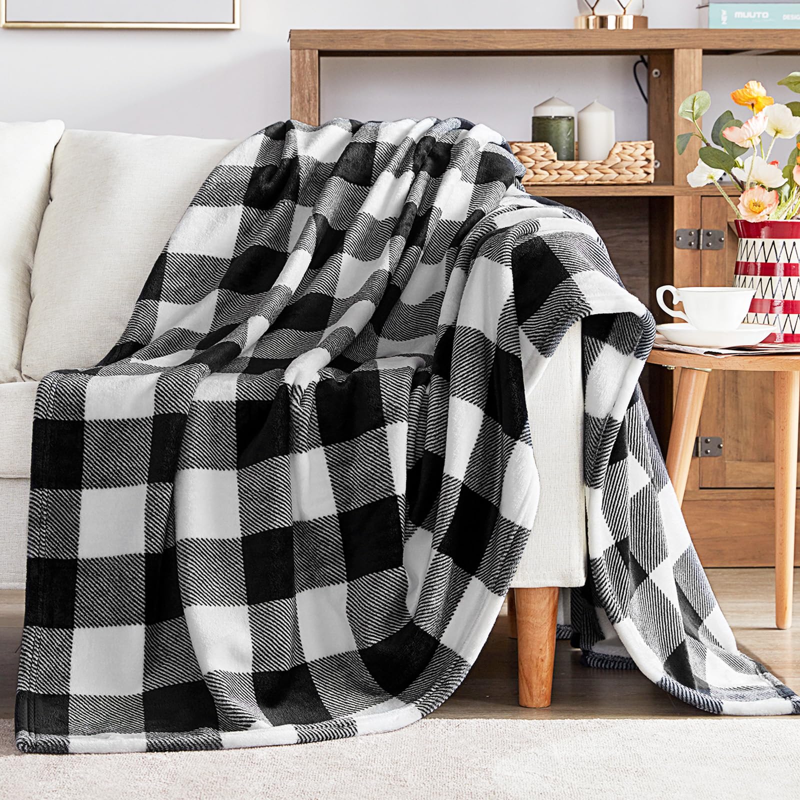 Black and white checkered blanket draped over a sofa in a cozy living room.