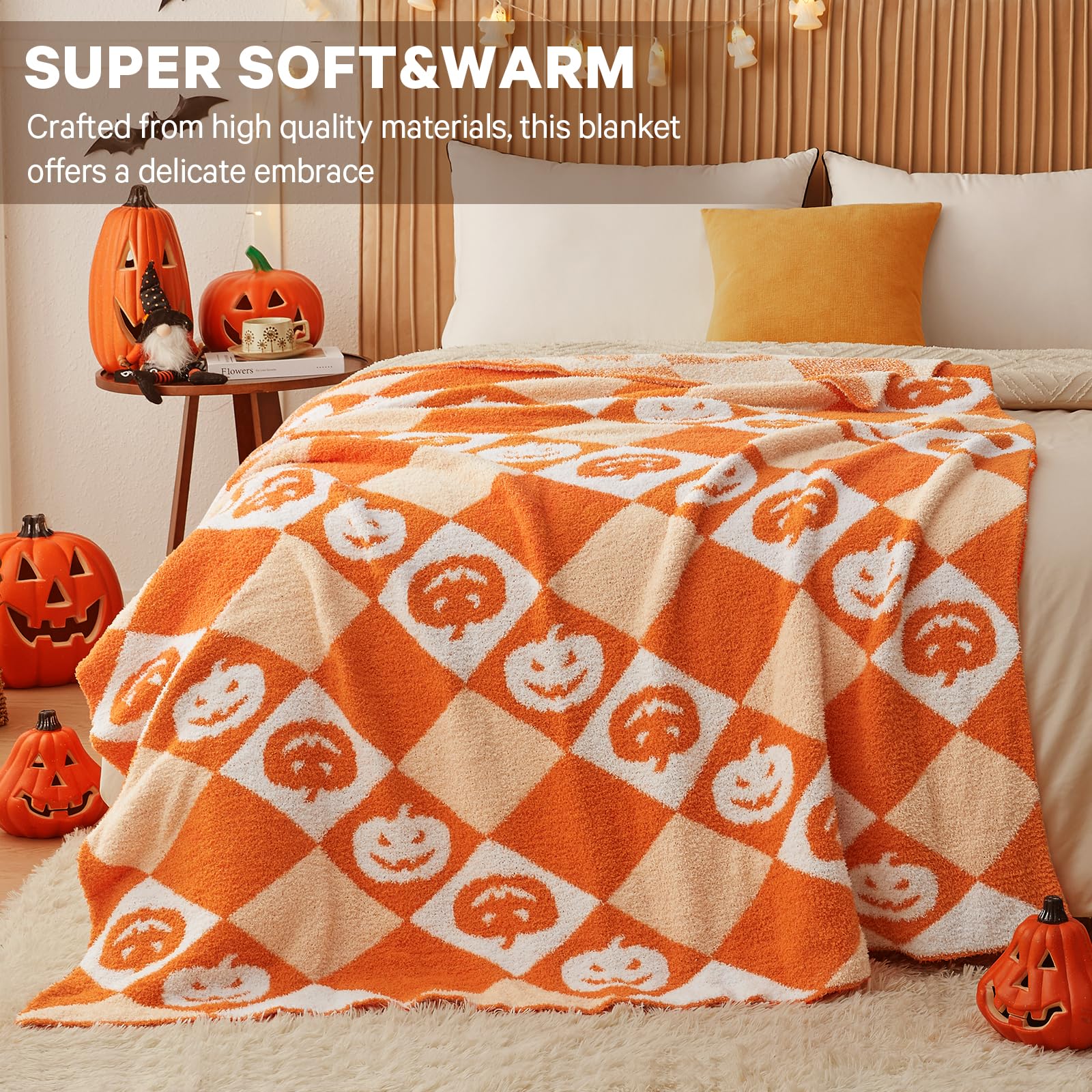 Orange and white checkered blanket with pumpkin pattern on a bed, surrounded by Halloween decor.