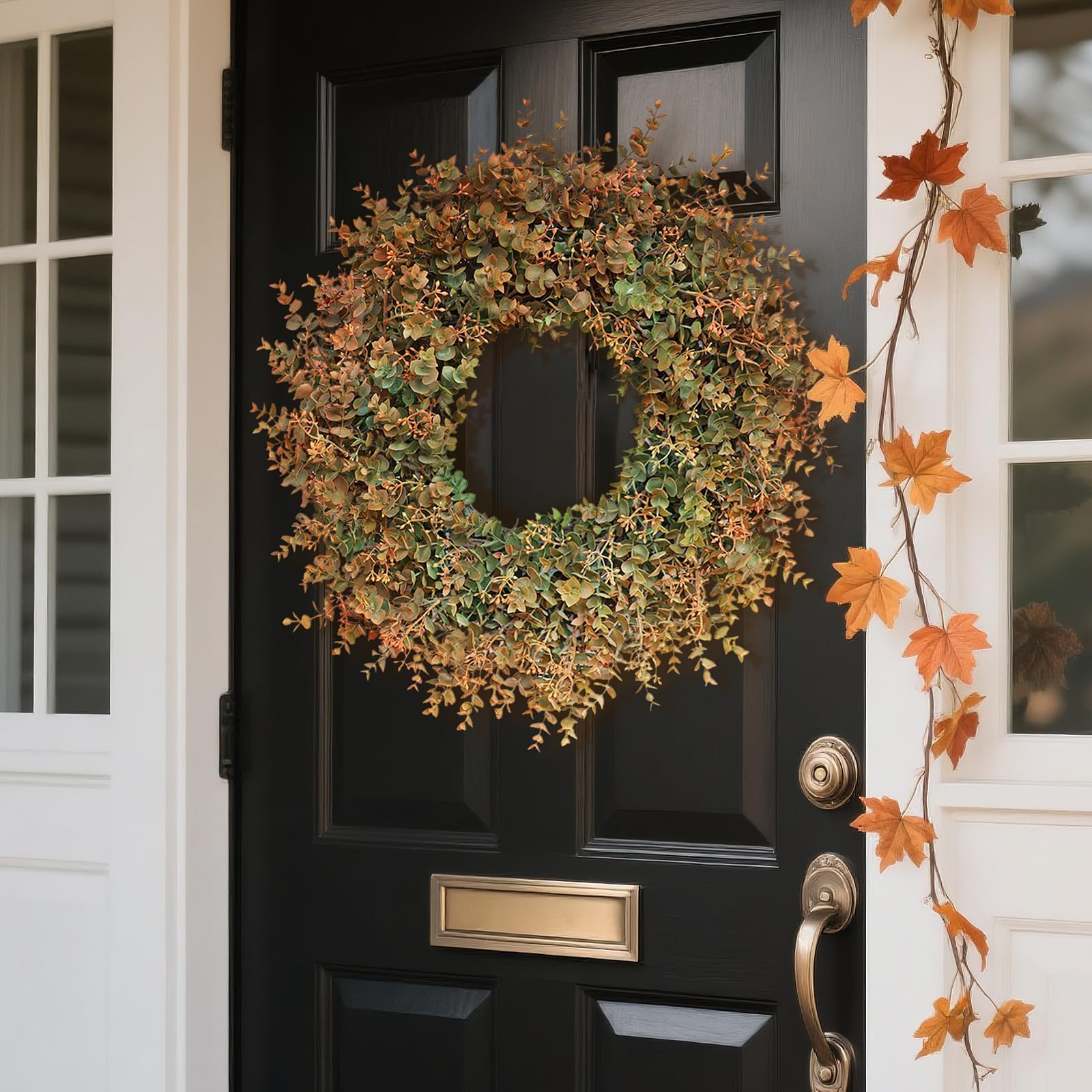 Decorative wreath on a black door with autumn leaf garland decoration