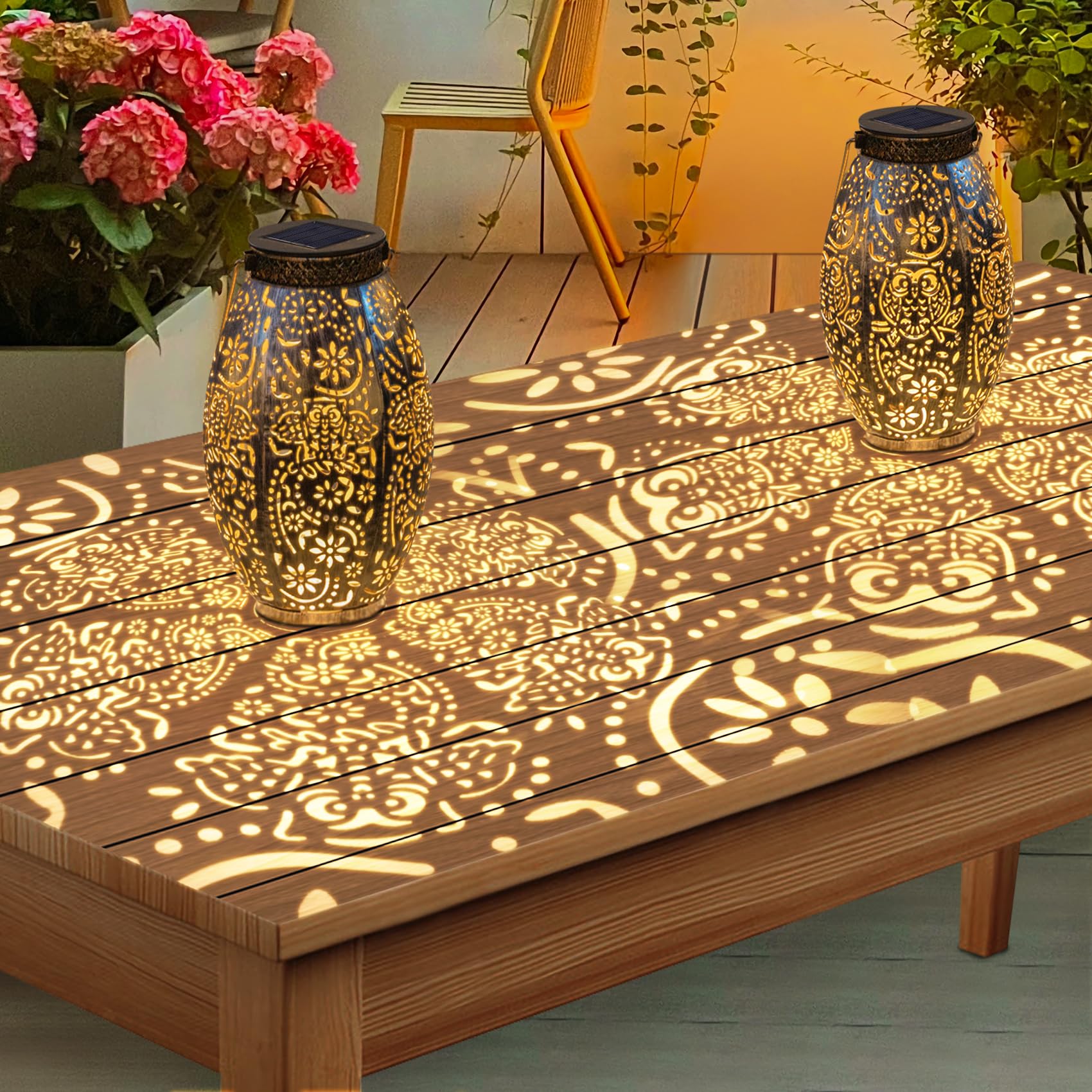 Decorative lanterns casting owl patterns on a wooden table outdoors.