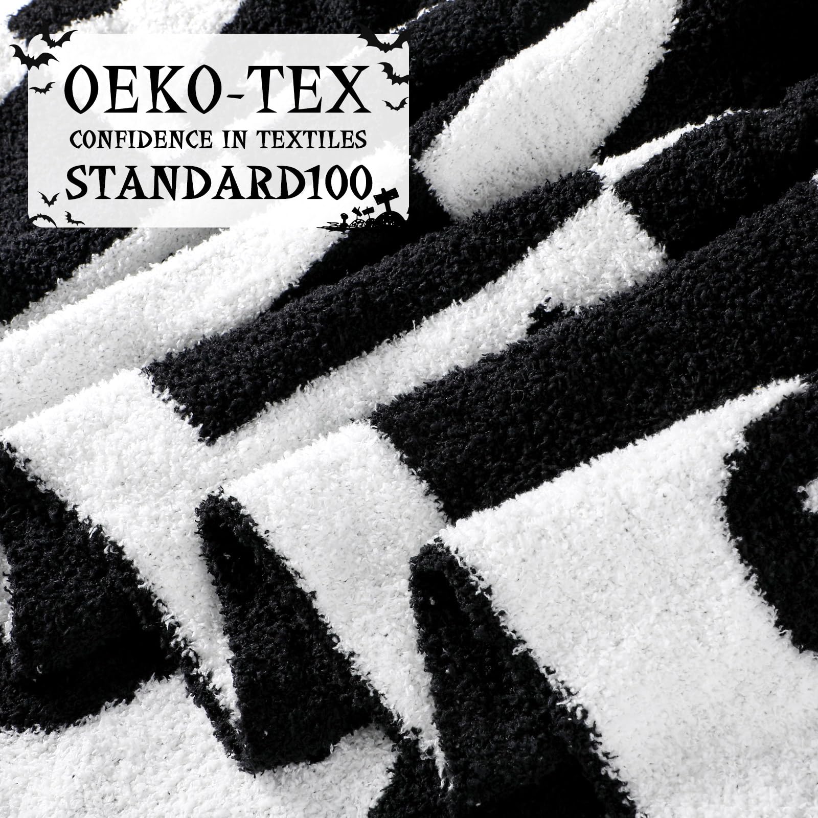 Blanket with black and white pattern and Oeko-Tex Standard 100 logo.