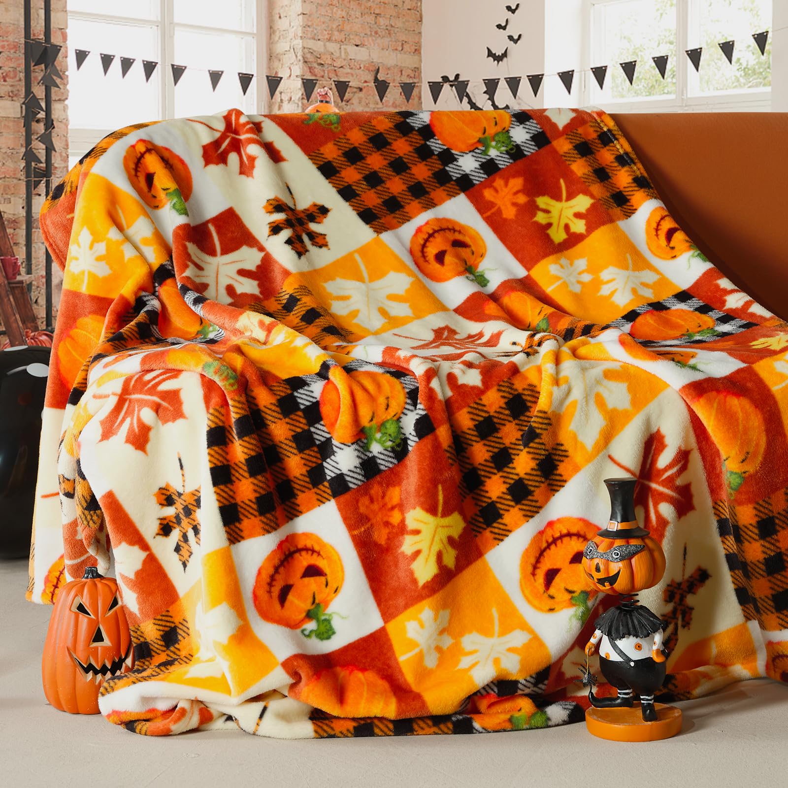 Halloween blanket with pumpkins and fall leaves.