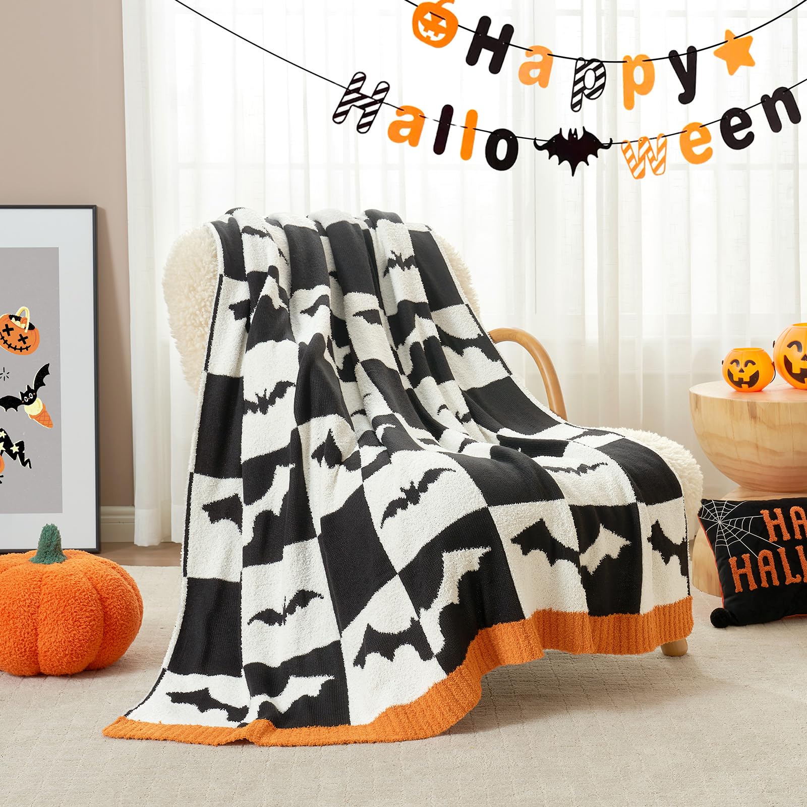 Halloween-themed blanket with bat pattern draped over a chair, surrounded by Halloween decorations.