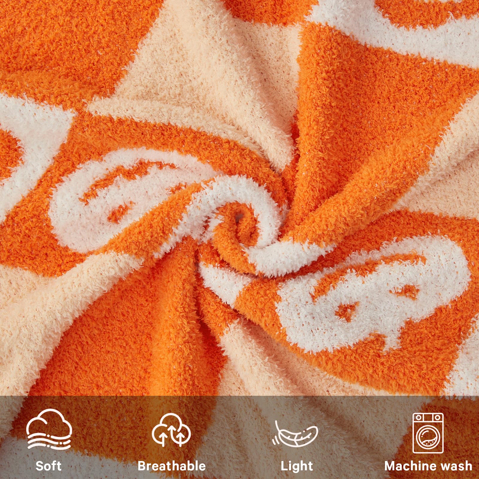 Close-up of orange and beige fabric with pumpkins and icons for softness, breathability, lightness, and machine washability.