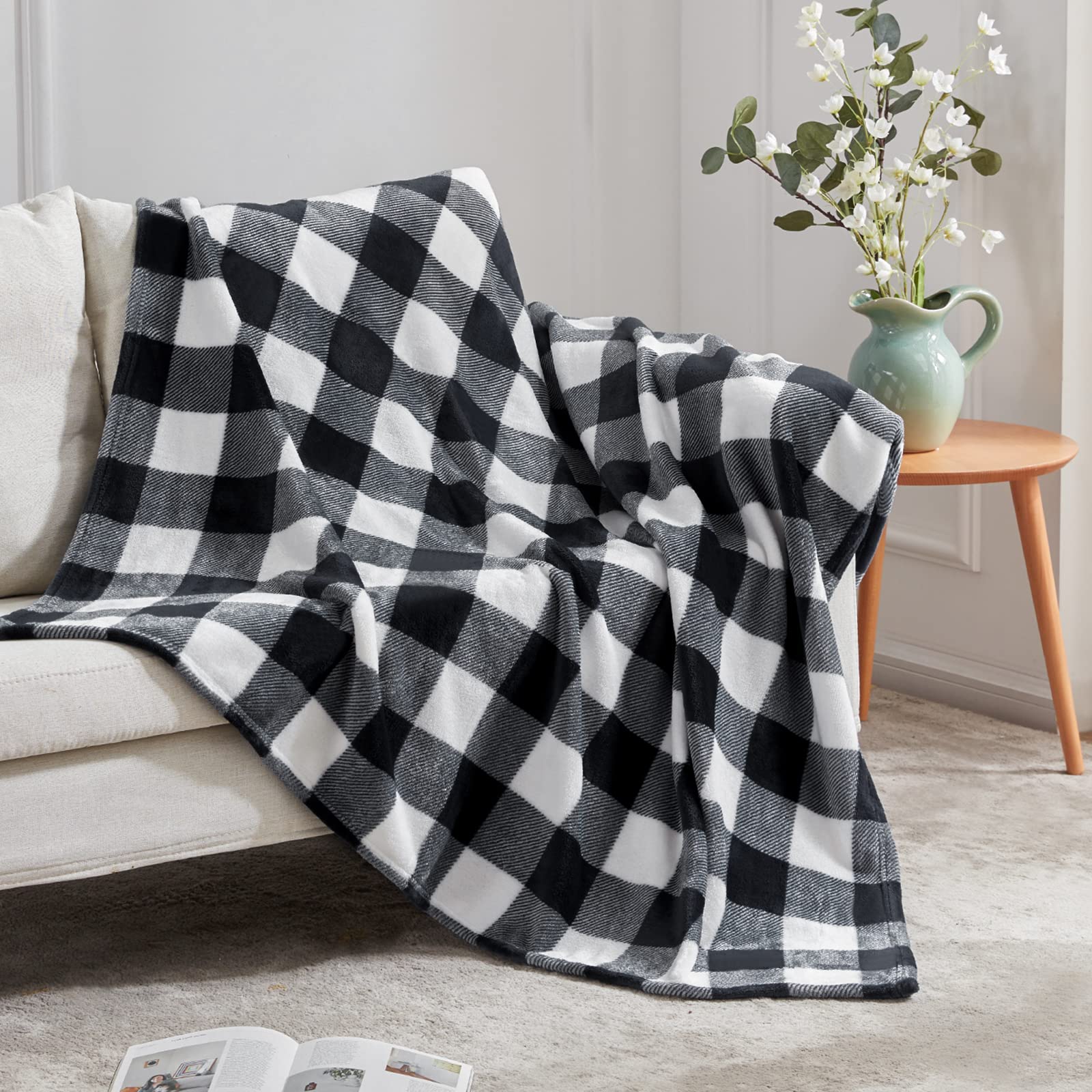 Black and white checkered blanket draped over a sofa in a living room setting.
