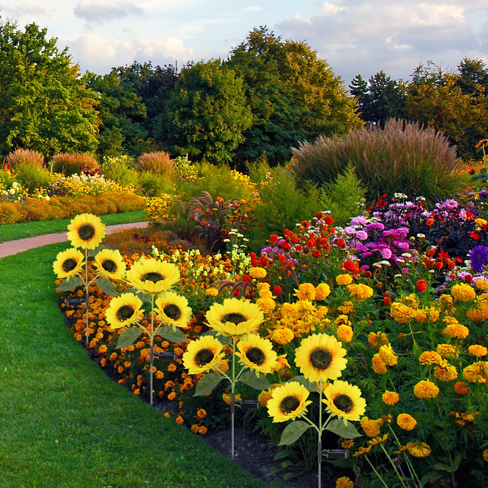 Colorful flower garden with sunflowers and various other plants in a garden setting.