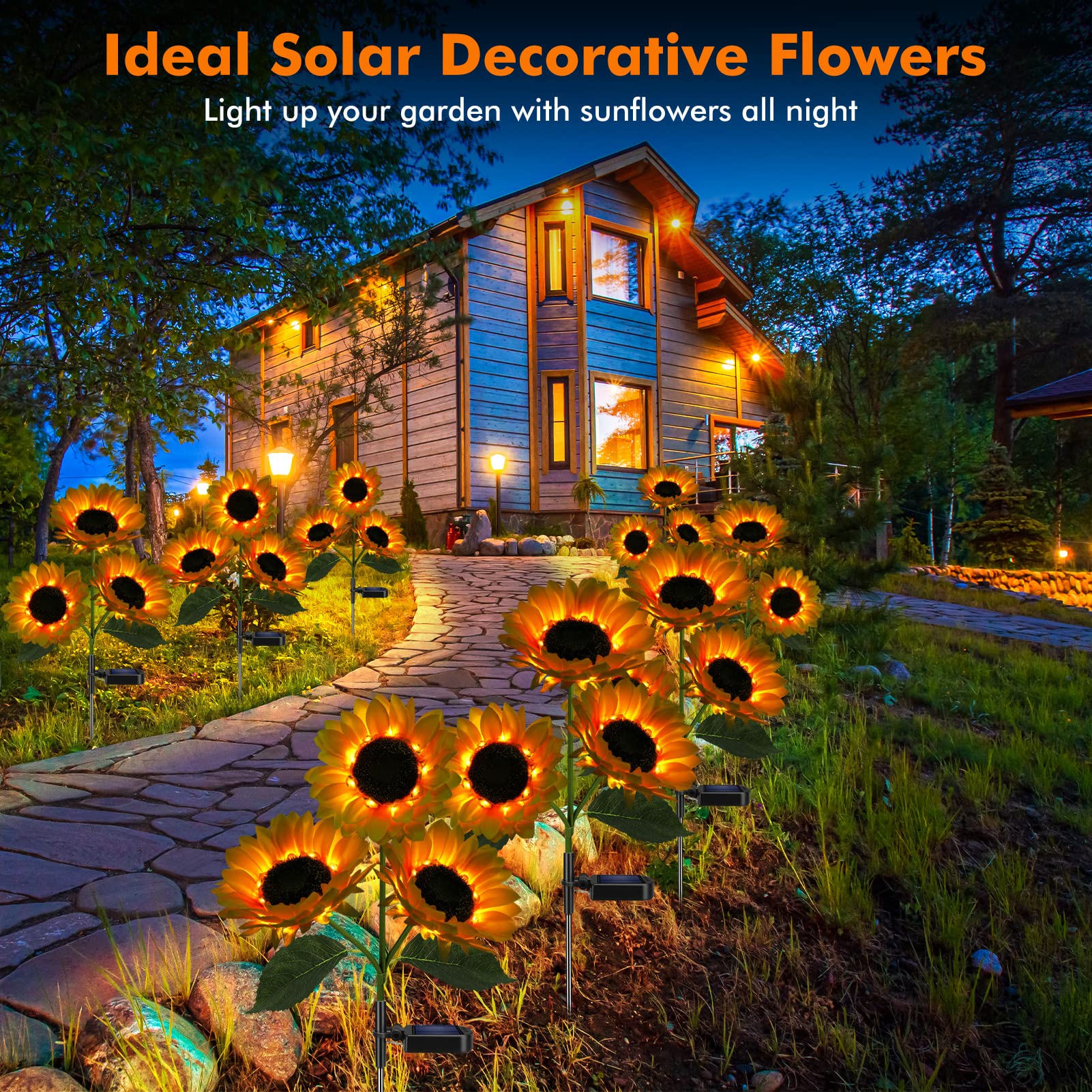 Solar decorative flowers illuminating a garden pathway in front of a house at night.